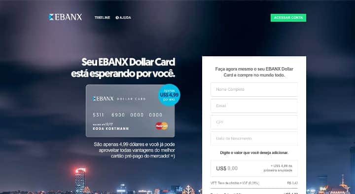 imagem cartão de crédito Dollar Card Ebanx ao lado de formulário sobre uma vista de uma cidade iluminada